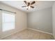 Cozy bedroom with neutral walls, tiled flooring, and a ceiling fan providing comfort at 14524 Dunrobin Dr, Wimauma, FL 33598