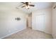 Neutral bedroom features tile flooring and a ceiling fan for comfortable living at 14524 Dunrobin Dr, Wimauma, FL 33598