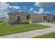 Charming home featuring a well-maintained lawn, 2 car garage, and mature landscaping at 14524 Dunrobin Dr, Wimauma, FL 33598