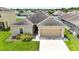 Charming single-story home with a two-car garage, manicured landscaping, and a welcoming entrance at 14524 Dunrobin Dr, Wimauma, FL 33598