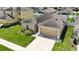 Charming home featuring a well-maintained lawn, 2 car garage, and mature landscaping at 14524 Dunrobin Dr, Wimauma, FL 33598