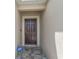 Close up of the front door and entryway of a home with secure lock and alarm system sign at 14524 Dunrobin Dr, Wimauma, FL 33598