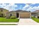 Charming single-story home with a well-maintained lawn and attached two-car garage in a sunny neighborhood at 14524 Dunrobin Dr, Wimauma, FL 33598