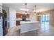 Kitchen with granite countertops, stainless steel appliances, tile backsplash, and an adjacent dining area with chandelier at 14524 Dunrobin Dr, Wimauma, FL 33598