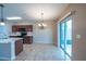Bright kitchen with modern appliances, granite countertops, tile backsplash, and access to the outdoor living area at 14524 Dunrobin Dr, Wimauma, FL 33598