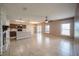 Open-concept living area featuring tile flooring, ample natural light, and a kitchen with stainless steel appliances at 14524 Dunrobin Dr, Wimauma, FL 33598