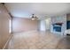 Spacious living area featuring tile floors, neutral paint, and an open layout with a kitchen area and fireplace at 14524 Dunrobin Dr, Wimauma, FL 33598