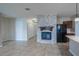 Living area with a fireplace and open access to the kitchen featuring stainless steel appliances and granite countertops at 14524 Dunrobin Dr, Wimauma, FL 33598