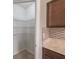 Walk-in pantry featuring ample shelving, providing efficient storage in this modern kitchen at 14524 Dunrobin Dr, Wimauma, FL 33598