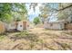 This backyard features a shed and a partially fenced yard with some trees at 1520 S Michigan Ave, Clearwater, FL 33756