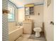 Small bathroom featuring outdated fixtures and blue trim around the bathtub and window at 1520 S Michigan Ave, Clearwater, FL 33756