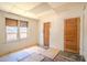 Bedroom with damaged floors, one window, and one closet with a wooden door at 1520 S Michigan Ave, Clearwater, FL 33756