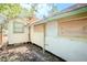 This is an exterior side view of the home showing boarded up windows at 1520 S Michigan Ave, Clearwater, FL 33756