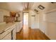 View of the kitchen, which contains outdated cabinets, pantry and appliances in need of renovations at 1520 S Michigan Ave, Clearwater, FL 33756