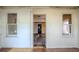 View of the main living area showing hardwood floors, two windows and passage to another room at 1520 S Michigan Ave, Clearwater, FL 33756