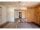 Spacious living room with hardwood floors, multiple doorways, and dated paneled wall at 1520 S Michigan Ave, Clearwater, FL 33756