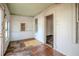 Enclosed porch featuring multiple windows, original woodwork and an open doorway to another room at 1520 S Michigan Ave, Clearwater, FL 33756
