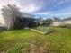 Large backyard with a screened patio and a garden, perfect for outdoor enjoyment and gardening at 1521 Atami Ct, Wesley Chapel, FL 33544