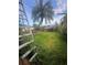 Lush backyard featuring a garden area and mature trees, creating a serene outdoor space at 1521 Atami Ct, Wesley Chapel, FL 33544