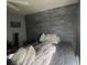 A bedroom with moody gray wall and a queen bed at 1521 Atami Ct, Wesley Chapel, FL 33544