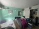 View of a bedroom with two beds, closet and colorful wall decorations at 1521 Atami Ct, Wesley Chapel, FL 33544