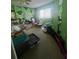 Bedroom with bright green walls, geometric pattern, and view of a window at 1521 Atami Ct, Wesley Chapel, FL 33544