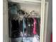 A closet containing clothing, helmets, hockey shoulder pads and storage containers at 1521 Atami Ct, Wesley Chapel, FL 33544