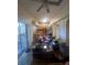 View of dining room and the kitchen beyond, featuring a ceiling fan and sliding glass doors at 1521 Atami Ct, Wesley Chapel, FL 33544