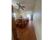 Spacious dining room includes ceiling fan, large window and wood flooring at 1521 Atami Ct, Wesley Chapel, FL 33544
