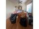 Bright dining room with hardwood floors, a ceiling fan, and a window for natural light at 1521 Atami Ct, Wesley Chapel, FL 33544