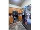 The kitchen features stainless steel appliances and light colored wood cabinets at 1521 Atami Ct, Wesley Chapel, FL 33544
