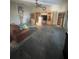 Open-concept living room with hardwood floors, a ceiling fan, and built-in shelving at 1521 Atami Ct, Wesley Chapel, FL 33544