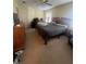 Main bedroom with a large bed, dresser, and a window with natural light at 1521 Atami Ct, Wesley Chapel, FL 33544
