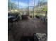 Screened-in porch with brick flooring, outdoor furniture, and views of a tropical landscape at 1521 Atami Ct, Wesley Chapel, FL 33544