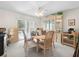 Bright dining room featuring an elegant china cabinet and sliding doors to the pool at 15711 Springmoss Ln, Tampa, FL 33624