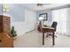 Bright home office featuring a wooden desk, ample storage, and soft blue walls with white trim at 15711 Springmoss Ln, Tampa, FL 33624