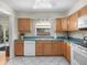 Eat-in kitchen featuring wood cabinets, tile flooring, and backyard access at 15711 Springmoss Ln, Tampa, FL 33624
