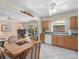 Eat-in kitchen featuring wood cabinets, tile flooring, and access to the backyard at 15711 Springmoss Ln, Tampa, FL 33624