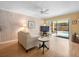 Cozy living room features wood paneling and sliding glass doors to a screened-in patio at 15711 Springmoss Ln, Tampa, FL 33624