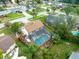Aerial view of a private screened-in pool offering a relaxing outdoor oasis and backyard at 15711 Springmoss Ln, Tampa, FL 33624