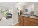 Wet bar area with wooden cabinets, a sink, and a view into the living room at 15711 Springmoss Ln, Tampa, FL 33624