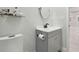 Clean bathroom with a gray vanity, round mirror, and modern fixtures offers a functional and stylish space at 15722 Gardenside Ln, Tampa, FL 33624