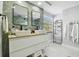 Elegant bathroom with double vanity, designer mirrors, and luxurious finishes at 15722 Gardenside Ln, Tampa, FL 33624