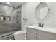 Modern bathroom features a stylish glass-enclosed shower with sleek tile, a contemporary vanity, and elegant fixtures at 15722 Gardenside Ln, Tampa, FL 33624