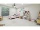 Charming bedroom with a pink bed, playful decor, ample storage, and a bright, welcoming atmosphere at 15722 Gardenside Ln, Tampa, FL 33624