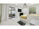 Bright bedroom with a sliding glass door to the lanai, white tile floors, modern curtains, and a contemporary light fixture at 15722 Gardenside Ln, Tampa, FL 33624