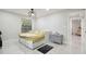 Bright bedroom with natural light, a modern light fixture, and neutral color palette at 15722 Gardenside Ln, Tampa, FL 33624