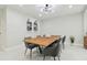 Beautiful dining room with a modern light fixture, sleek chairs, and a wooden table for elegant gatherings at 15722 Gardenside Ln, Tampa, FL 33624