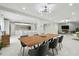 Bright, open-concept dining room with modern lighting, sleek tile floors, and a contemporary table for stylish gatherings at 15722 Gardenside Ln, Tampa, FL 33624