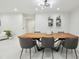 Well-lit dining room showcasing a modern table, contemporary lighting, and pristine white walls for a clean, sophisticated look at 15722 Gardenside Ln, Tampa, FL 33624
